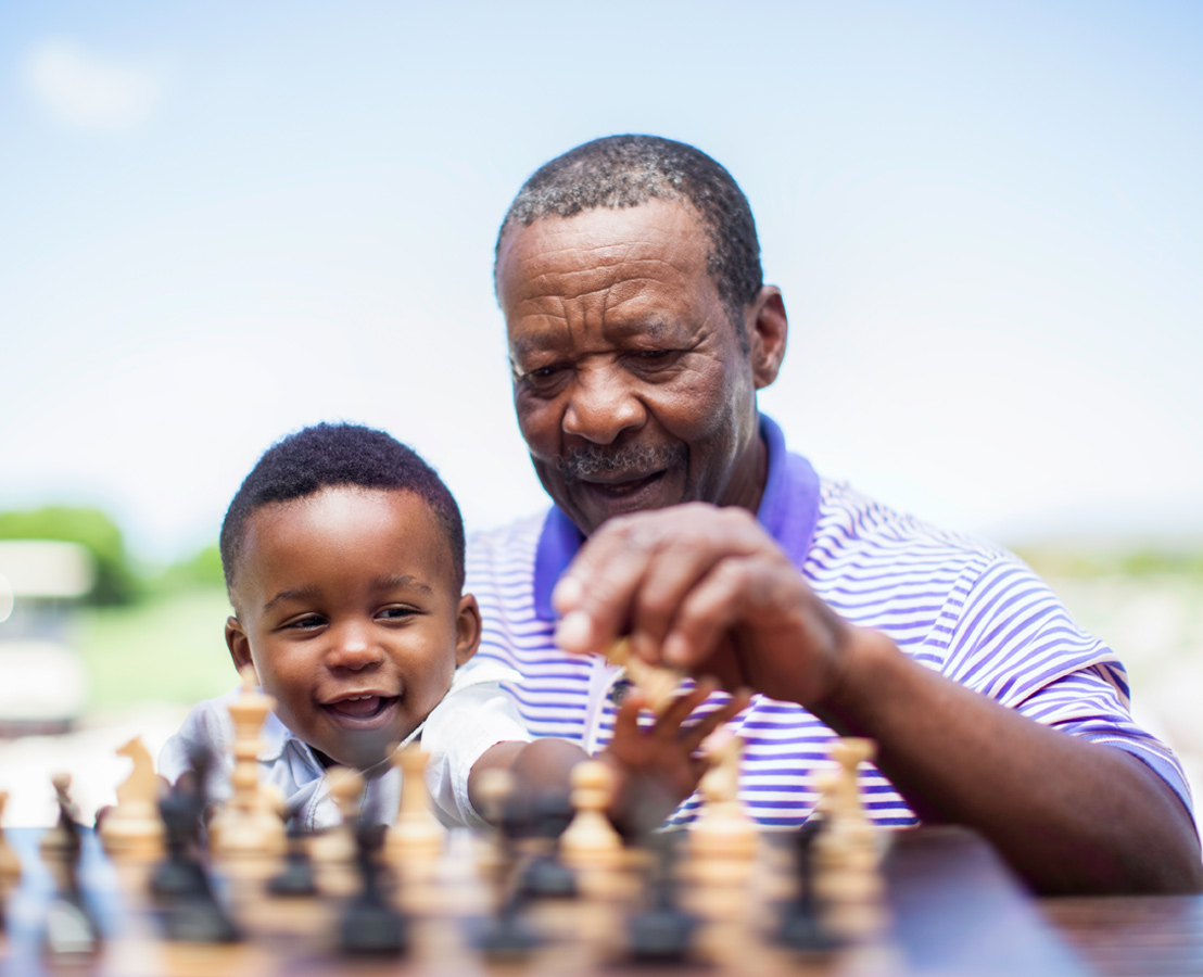 Smiling African father and young child outdoors, with text overlay 'Global Healthcare Gateway™' describing a platform that provides global access to specialized healthcare services and infrastructure.